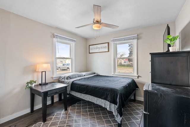 bedroom featuring wood finished floors, baseboards, and ceiling fan