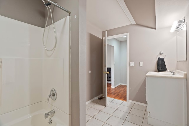 bathroom featuring baseboards, shower / tub combination, vanity, and tile patterned flooring