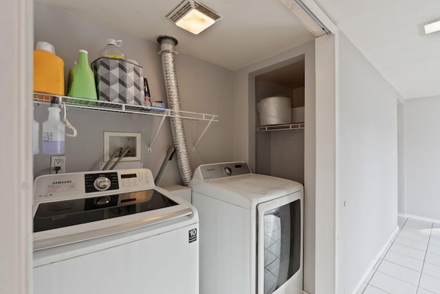 laundry area featuring washer and dryer, visible vents, baseboards, and tile patterned flooring