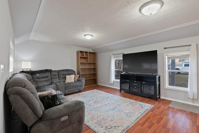 living room featuring vaulted ceiling, wood finished floors, baseboards, and a textured ceiling