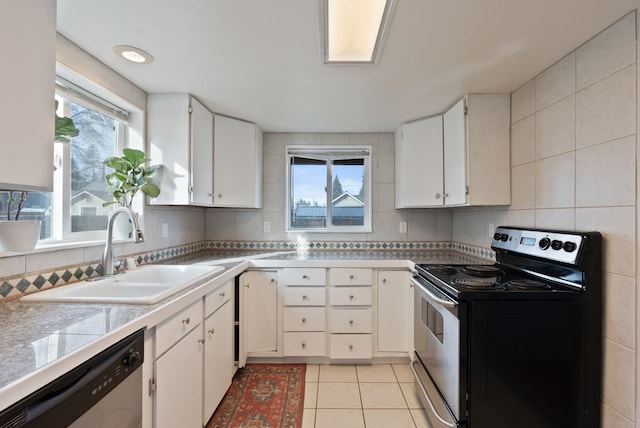 kitchen featuring a sink, light tile patterned floors, a wealth of natural light, and stainless steel appliances