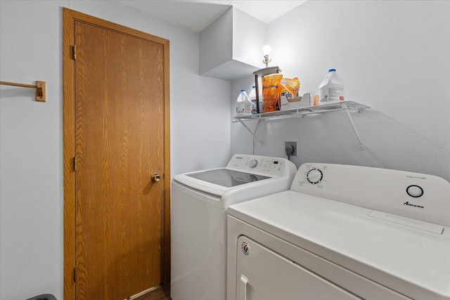 washroom featuring washing machine and clothes dryer and laundry area