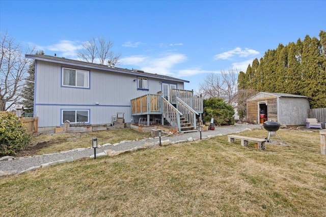 rear view of house featuring a shed, fence, a yard, stairway, and an outdoor structure