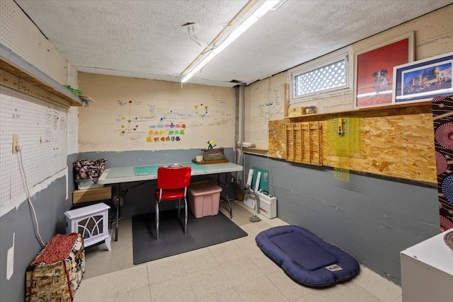 office area featuring tile patterned floors, a workshop area, and a textured ceiling