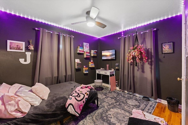 bedroom with a ceiling fan and wood finished floors