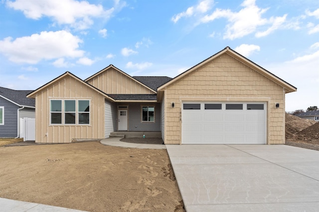 single story home featuring board and batten siding, fence, a garage, and driveway