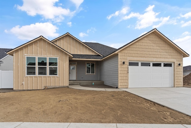 ranch-style house featuring concrete driveway, a garage, board and batten siding, and roof with shingles