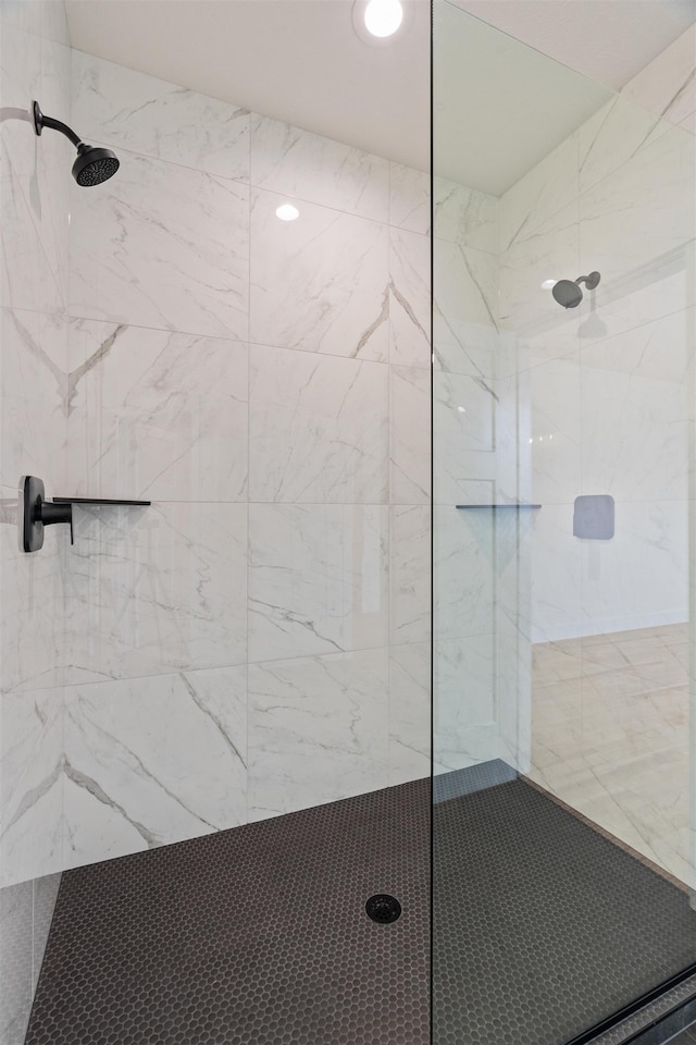 full bathroom featuring a marble finish shower