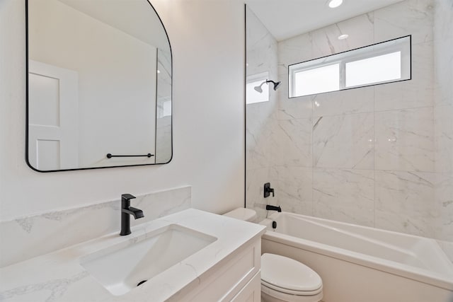 bathroom with toilet, vanity, and  shower combination