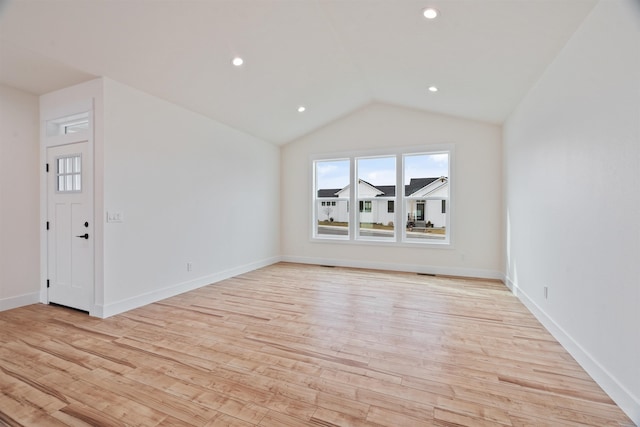 empty room with recessed lighting, vaulted ceiling, and light wood finished floors