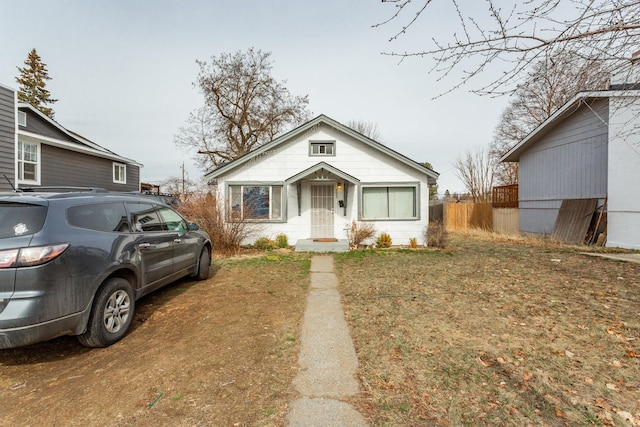 bungalow-style house featuring fence