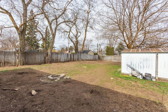 view of yard featuring a fenced backyard, a storage shed, and an outdoor structure