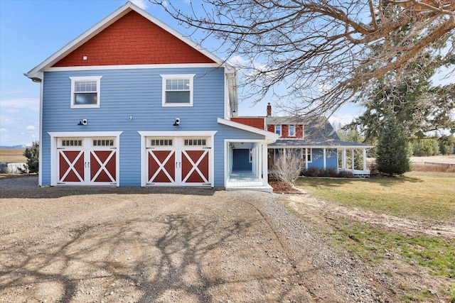 view of front of home with a front yard, a garage, and driveway