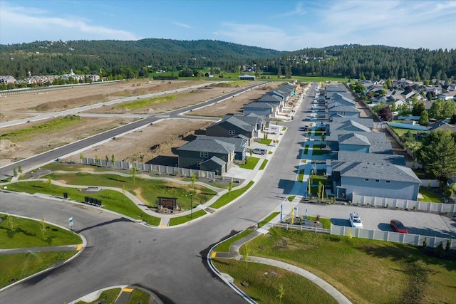 bird's eye view with a wooded view