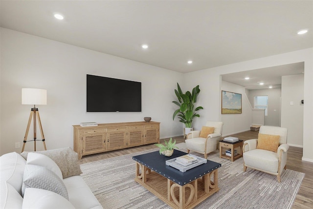 living area featuring recessed lighting, baseboards, and light wood finished floors