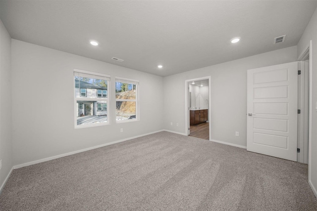 unfurnished bedroom with recessed lighting, visible vents, baseboards, and carpet