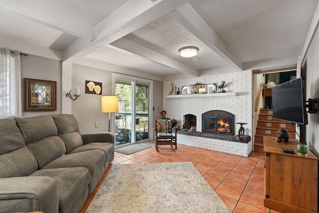 living room featuring light tile patterned floors, beamed ceiling, and a brick fireplace