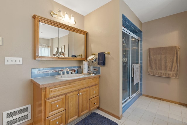 full bathroom with visible vents, a stall shower, vanity, and baseboards