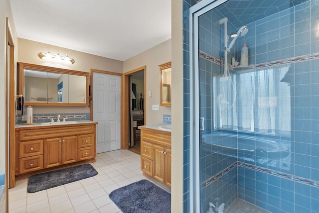 full bathroom with tile patterned floors, a shower stall, and vanity