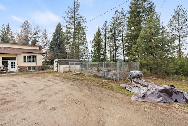 view of yard with a storage shed, an outdoor structure, and central air condition unit