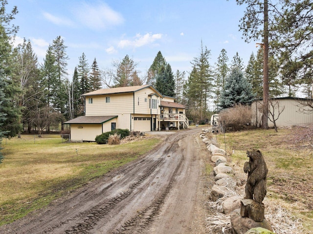 exterior space with a lawn, driveway, and an attached garage