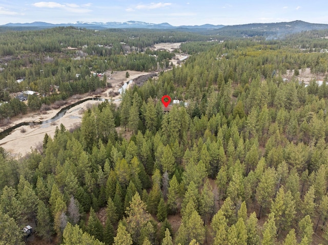 birds eye view of property featuring a mountain view and a forest view