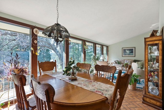 dining room with lofted ceiling and brick floor