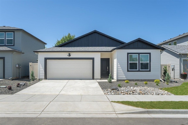 view of front facade featuring board and batten siding, concrete driveway, and a garage