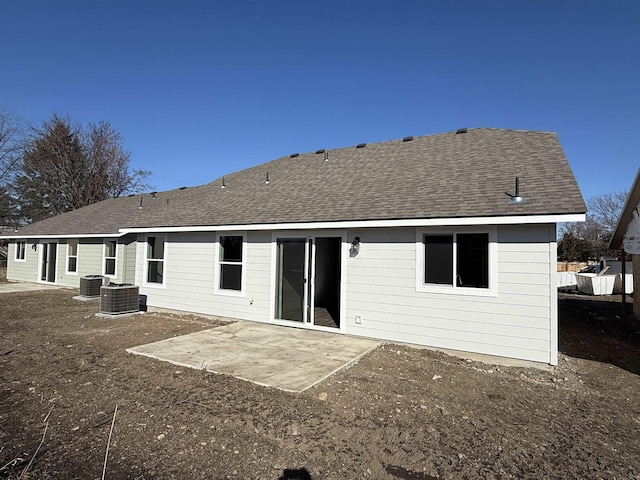 back of house featuring a patio area, cooling unit, and roof with shingles