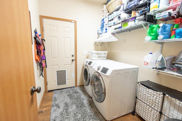 laundry area featuring light wood finished floors, laundry area, and separate washer and dryer