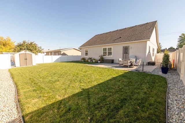 back of house with an outbuilding, a lawn, a fenced backyard, a storage shed, and a patio area