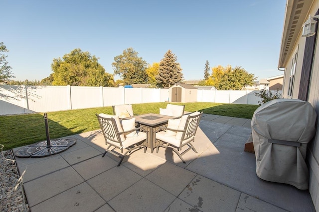 view of patio with an outbuilding, a fenced backyard, and a shed