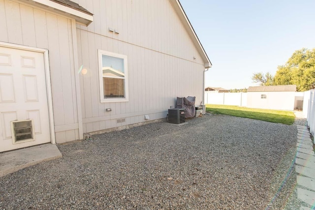 view of home's exterior featuring crawl space, cooling unit, and fence