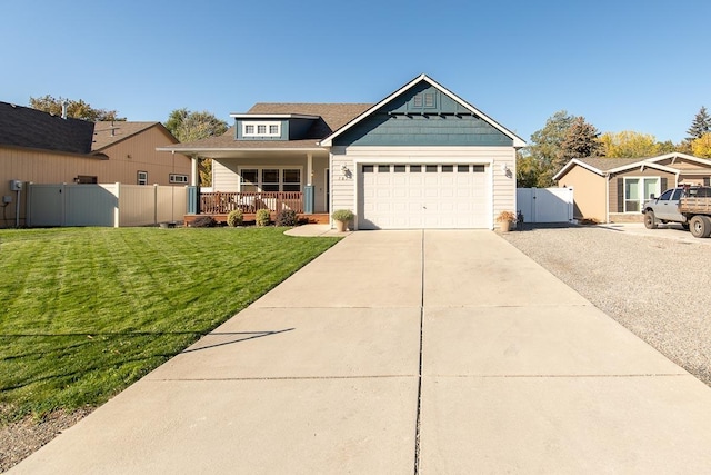 craftsman inspired home with a front lawn, fence, a porch, concrete driveway, and a gate