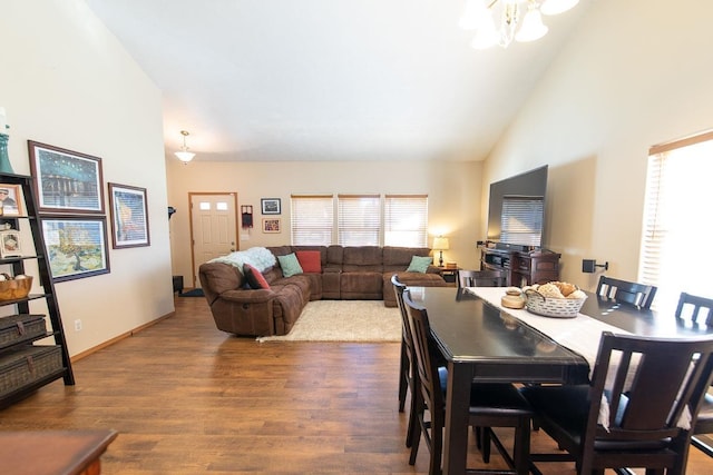 dining area featuring plenty of natural light, wood finished floors, baseboards, and high vaulted ceiling