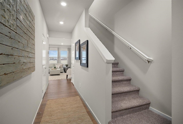 corridor featuring stairway, recessed lighting, wood finished floors, and baseboards