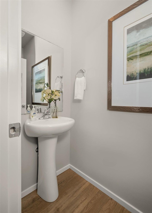 bathroom featuring baseboards and wood finished floors