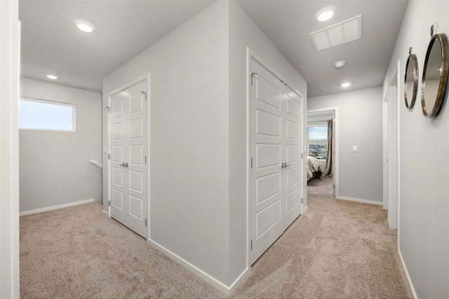 hall with recessed lighting, carpet flooring, baseboards, and visible vents