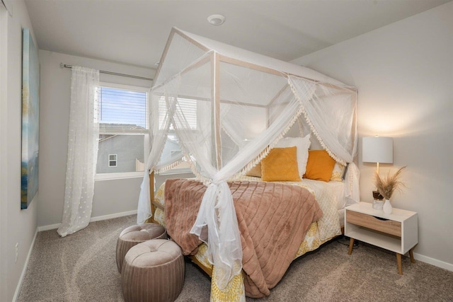 bedroom with baseboards and carpet