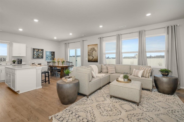 living room featuring recessed lighting and light wood-style flooring