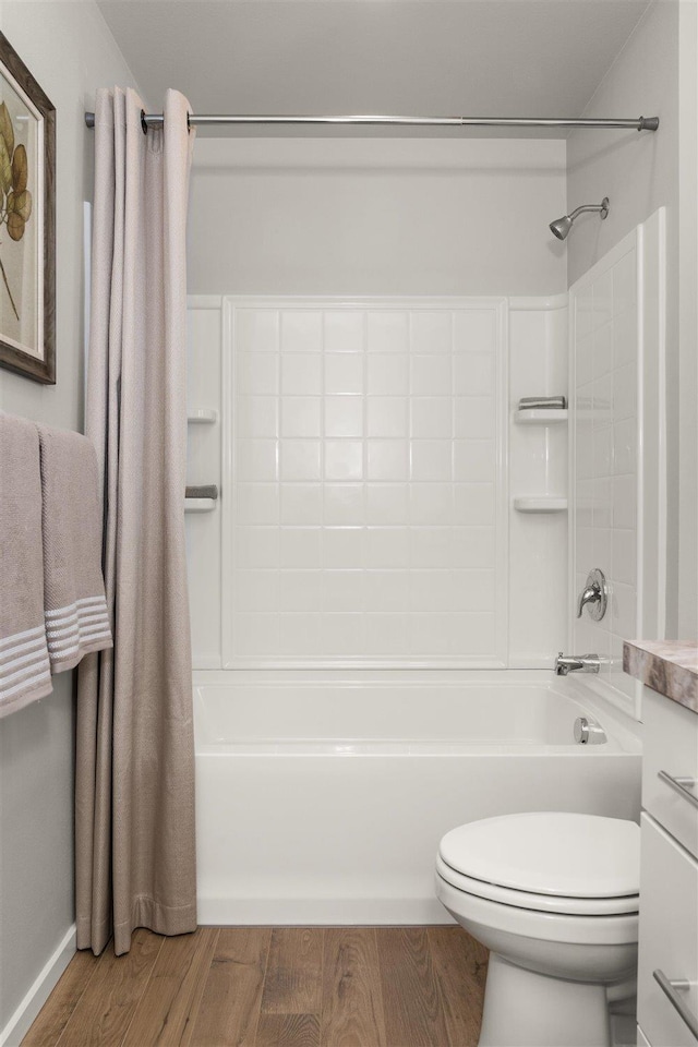 bathroom with vanity, toilet, shower / bathing tub combination, and wood finished floors