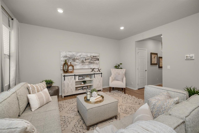 living room featuring recessed lighting, baseboards, and wood finished floors