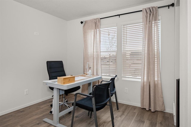 office area with baseboards and wood finished floors