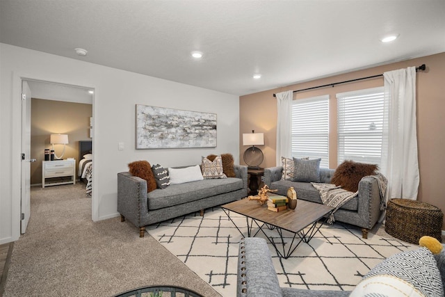 living room with recessed lighting, light colored carpet, and baseboards