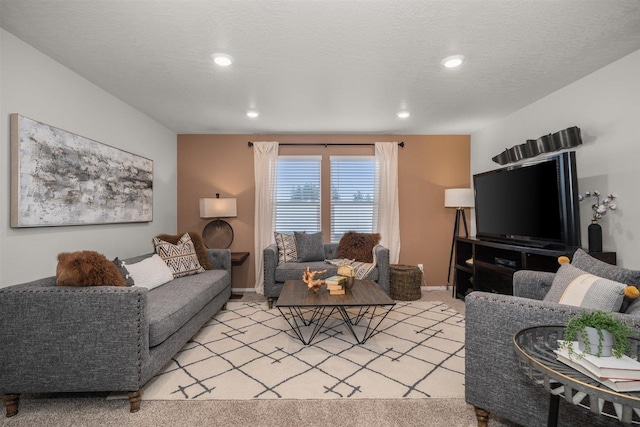 living area featuring recessed lighting, light colored carpet, baseboards, and a textured ceiling