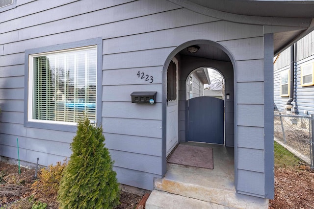 property entrance with fence and a gate