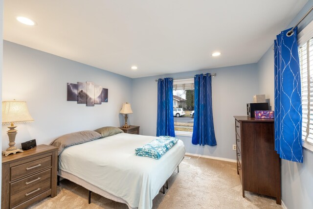 bedroom featuring light carpet, recessed lighting, baseboards, and multiple windows