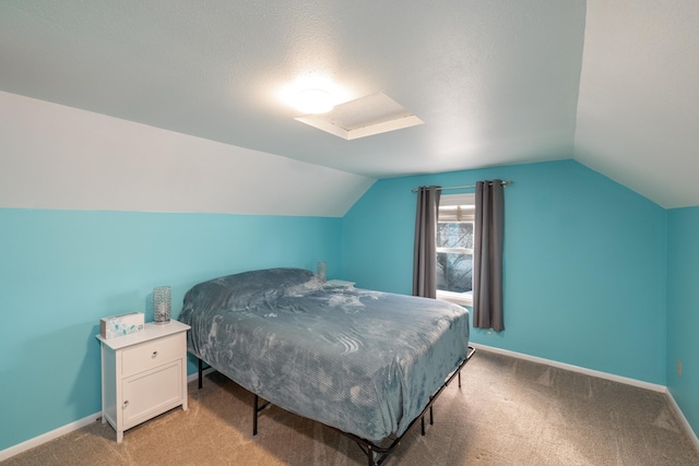 bedroom with light colored carpet, lofted ceiling, and baseboards