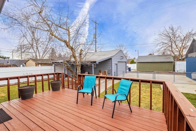 wooden deck featuring an outdoor structure, a yard, fence private yard, and a detached garage