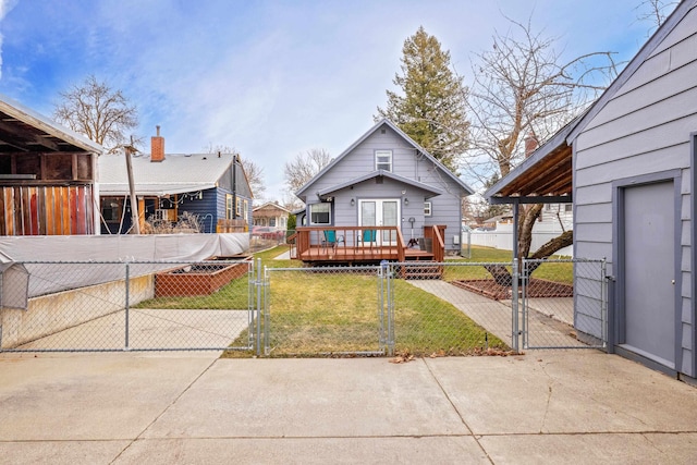 view of front facade with fence private yard, a wooden deck, a front lawn, and a gate